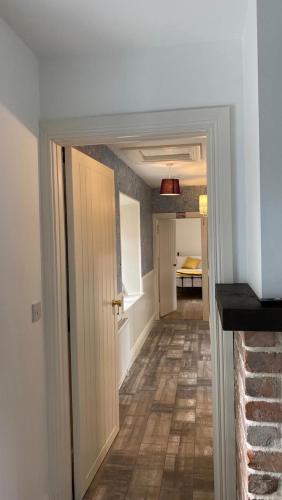 a hallway with a door open to a room at Toddys Cottage & Stables in Cavan