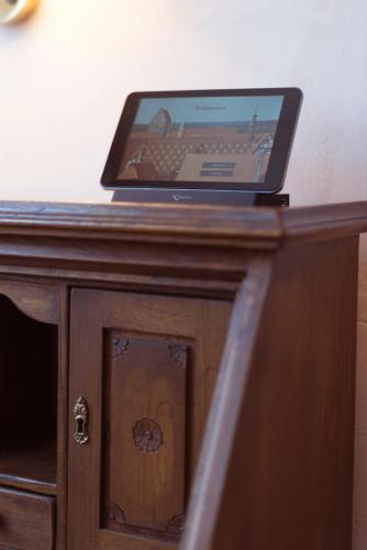 a laptop computer sitting on top of a wooden table at Hotel Deutsches Haus in Dinkelsbühl