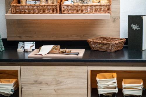 a counter with a table with a plate of food at Ferienhotel Gut Enghagen in Rossleithen