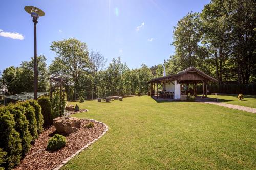 a gazebo with a pavilion in a park at Apartmány Jožák in Arnoltice u Decina