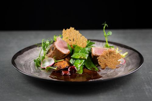 a plate of food on a table at IBB Hotel Grand Hotel Lublin in Lublin