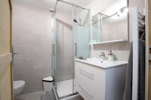 une salle de bain avec un lavabo blanc et une douche dans l'établissement 7 DELOYE - Charmant 2 pieces rénové - Dernier étage - Clim, à Nice