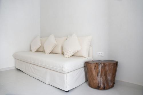 a white couch with pillows on top of it at Blanco Rooms Mykonos in Mýkonos City