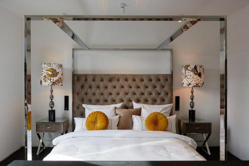 a bedroom with a large white bed with yellow pillows at hotel friends Essen Zeche Zollverein in Essen