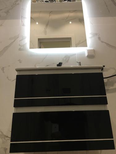 a bathroom with a sink and a mirror at Ria Studios in Olhão