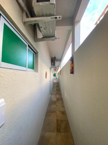 an empty hallway in a building with a green sign on the wall at Pousada da Celma in Fortaleza