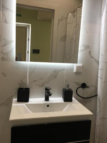 a bathroom with a sink and a mirror at Ria Studios in Olhão