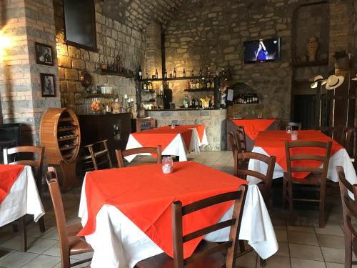 a restaurant with red tables and chairs and a bar at Casale Antonietta in Sorrento