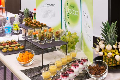 a buffet of fruit and juice and drinks on a table at Novotel Nice Arenas Aeroport in Nice