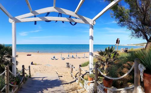 a beach with people on the sand and the ocean at Villaggio Camping Oasi in Vieste