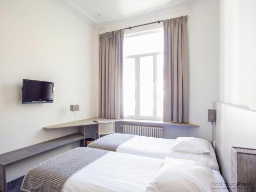 Postel nebo postele na pokoji v ubytování Hotel Du Congres