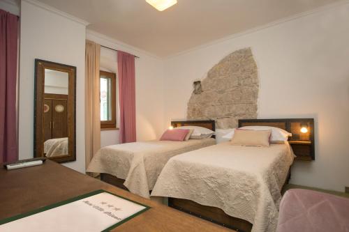 a hotel room with two beds and a table at Hotel Villa Diana in Split