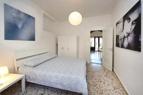a bedroom with a bed and a table and posters at Casa Pirri in Castelmola
