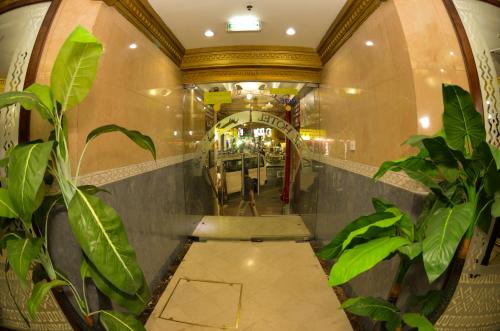 a hallway with potted plants in a shopping mall at Index Hotel in Dubai