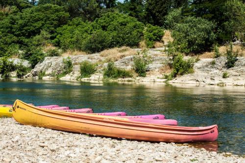 a group of boats sitting on the shore of a river at Rue du Château in Tarascon