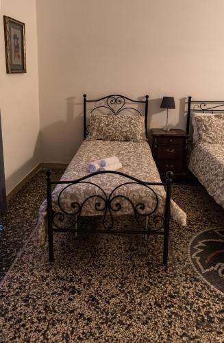 a bedroom with a black bed with a towel on it at Antica Terrazza Frascati in Frascati