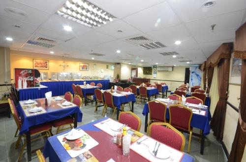 a dining room with blue tables and chairs at Index Hotel in Dubai