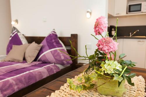 a table with a vase with flowers on it at Pension SiLa in Groß-Umstadt