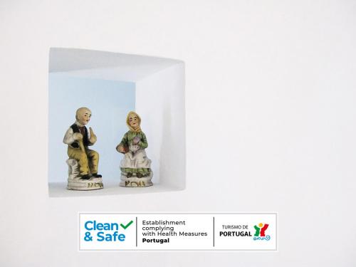 two figurines of a man and a woman in a box at Casa da Bica d'Água in Óbidos