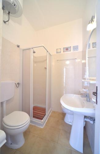 a bathroom with a toilet and a sink and a shower at Case vacanza Barbatoja in Fetovaia