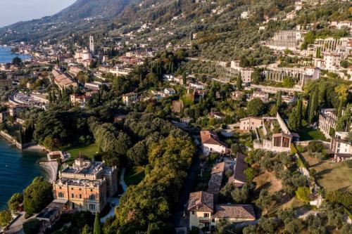 an aerial view of a town on a hill next to the water at Uliveto - Apartment in olive grove directly on the lake in Gargnano