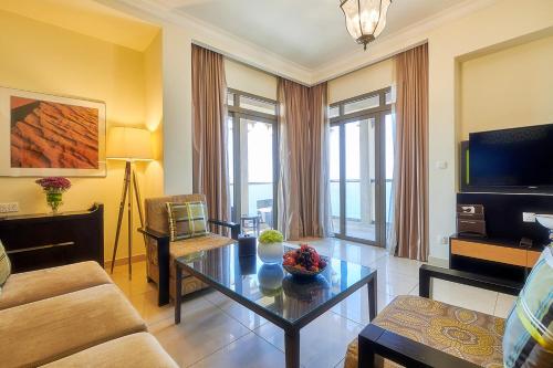 a living room with a couch and a table at Bahi Ajman Palace Hotel in Ajman 