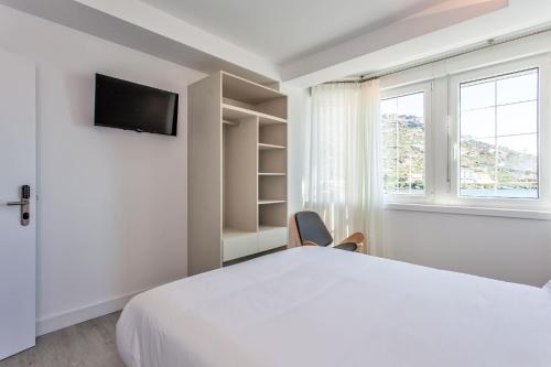 Posteľ alebo postele v izbe v ubytovaní Mar do Ézaro - Boutique Hotel