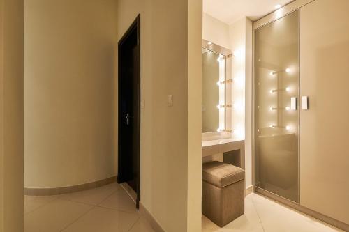 a bathroom with a walk in shower and a toilet at Bahi Ajman Palace Hotel in Ajman 