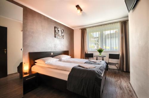 a bedroom with a large bed in a room at Willa Luiza in Wisła