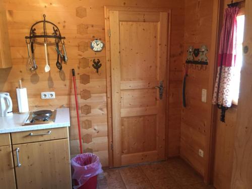 a kitchen with a wooden door in a room at Blockhaus-Traum Huber in Garmisch-Partenkirchen
