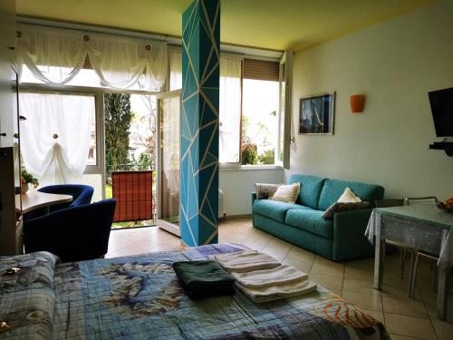 a living room with a bed and a couch at Garda Apartments in Euroresidence in Garda