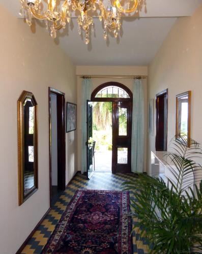 a hallway with a chandelier and an entry way at Villa Erika Madeira in Caniço