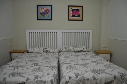 a bedroom with a bed and two pictures on the wall at Estudio Puerta del Sol Esparteros in Madrid
