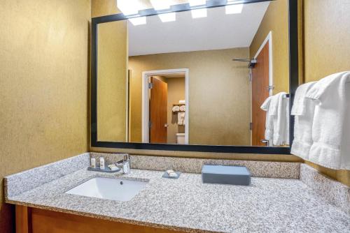 a bathroom with a sink and a large mirror at La Quinta by Wyndham Coeur d`Alene in Coeur d'Alene