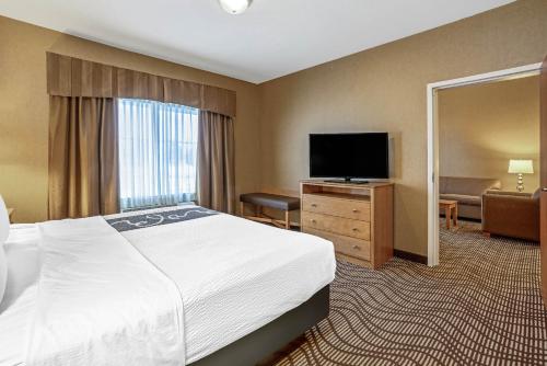 a hotel room with a bed and a flat screen tv at La Quinta by Wyndham Coeur d`Alene in Coeur d'Alene