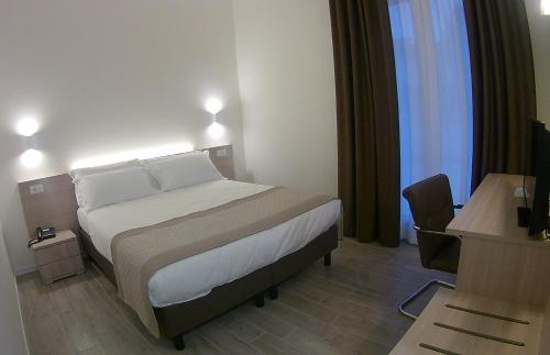 a hotel room with a bed and a desk and a desk at Hotel Nuova Mestre in Mestre
