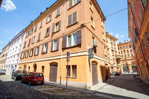 a red car parked in front of a building at casapalestro8#2 in Modena