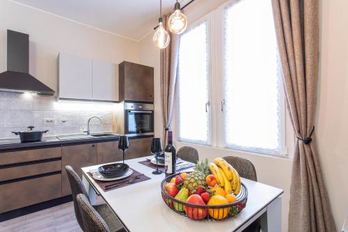 a kitchen with a table with a bowl of fruit on it at casapalestro8#2 in Modena