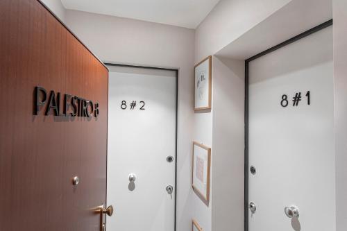 a hallway with two doors with numbers on them at casapalestro8#2 in Modena
