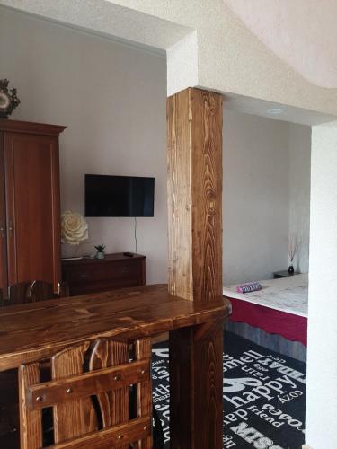 a room with a desk and a bed and a television at Apartment on Zarvanskaya in Old Town in Kamianets-Podilskyi