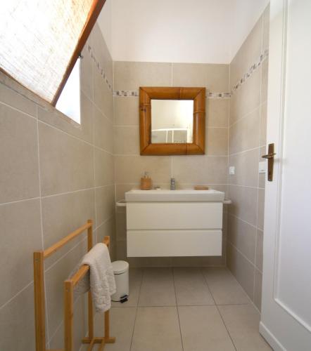 a bathroom with a sink and a mirror at Case vacanza Barbatoja in Fetovaia
