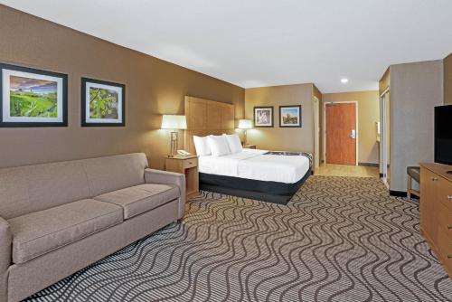 a hotel room with a bed and a couch at La Quinta by Wyndham Coeur d`Alene in Coeur d'Alene