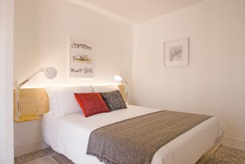 a bedroom with a white bed with two pillows at Margueda in Alcains