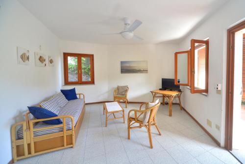 a living room with a couch and chairs and a table at Case vacanza Barbatoja in Fetovaia