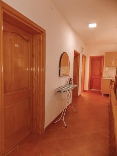 a hallway with a table and a door in a room at Guest house Naser in Ulcinj