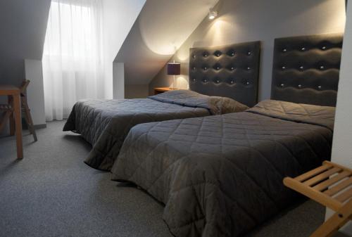 A bed or beds in a room at Les quatre vents
