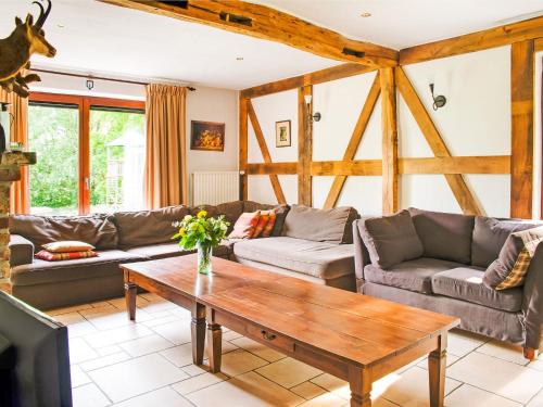 a living room with couches and a coffee table at Lavish Holiday Home in Malmedy with Sauna in Longfaye