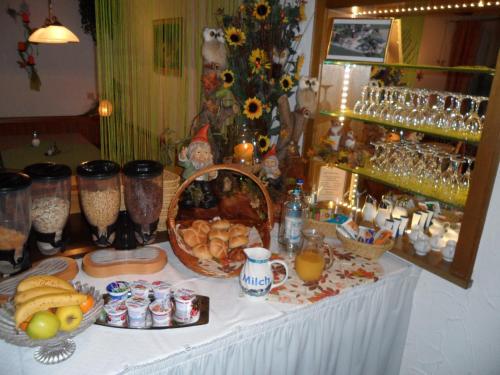 a table with food and other items on it at Hotel Hutzenthaler in Bruckberg