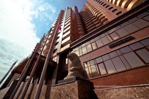 a statue of a lion in front of a building at King Hotel Astana in Astana