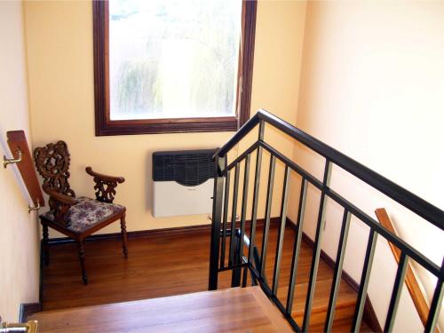 a room with a staircase with a chair and a window at Nuevos Horizontes in Tandil